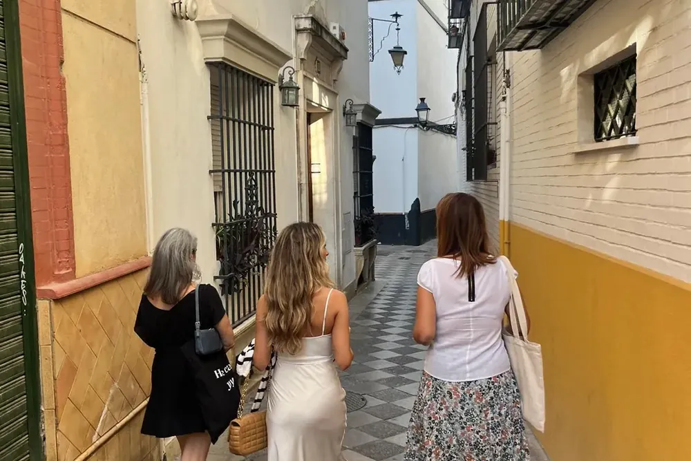 Walking a narrow street of the Santa Cruz quarter, the old Jewish quarter of Seville